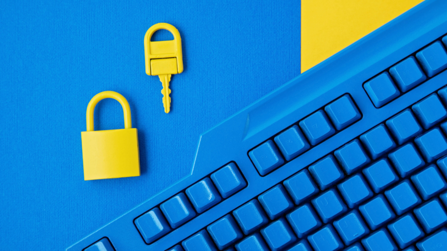 Cyber data and information security idea. Yellow padlock and key and blue keyboard. Computer, information safety, confidentiality concept